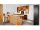 Home wet bar features wood cabinets, marble countertop, and a decorative wood bar at 30082 Troutdale Ridge Rd, Evergreen, CO 80439