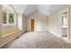 Large room featuring vaulted ceiling, wood bench seat, and a door to the ensuite bathroom at 30082 Troutdale Ridge Rd, Evergreen, CO 80439