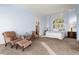 Spacious bedroom with seating area, arched window, and two side tables with lamps at 30082 Troutdale Ridge Rd, Evergreen, CO 80439