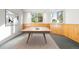 Recreation room features a ping pong table, wood paneling, and bright windows at 30082 Troutdale Ridge Rd, Evergreen, CO 80439