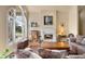 Bright living room with large arched windows offering a beautiful view, along with a fireplace at 30082 Troutdale Ridge Rd, Evergreen, CO 80439
