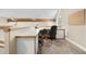 Loft office space with built-in desk, cabinets, natural light and neutral color palette at 30082 Troutdale Ridge Rd, Evergreen, CO 80439