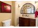 Charming bathroom featuring a wood vanity with a stone countertop and a decorative mirror at 5549 Lake Gulch Rd, Castle Rock, CO 80104