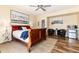 Comfortable bedroom with a wooden bed frame, ceiling fan, and adjacent seating area at 5549 Lake Gulch Rd, Castle Rock, CO 80104