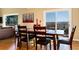 Cozy dining area with wood table, seating for six, and sliding glass doors offering scenic views at 5549 Lake Gulch Rd, Castle Rock, CO 80104