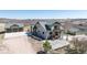 Expansive outdoor living area with stone patio, balcony, and detached two-car garage at 5549 Lake Gulch Rd, Castle Rock, CO 80104