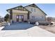Inviting front entrance with brick accents and a concrete driveway and walkway at 5549 Lake Gulch Rd, Castle Rock, CO 80104