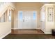 Bright and airy foyer with a white front door and decorative accents at 5549 Lake Gulch Rd, Castle Rock, CO 80104