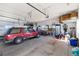 Spacious garage interior with a red SUV parked inside, showcasing storage and utility at 5549 Lake Gulch Rd, Castle Rock, CO 80104