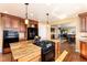 Open kitchen with a center island with gas cooktop, stainless appliances, and seamless living space access at 5549 Lake Gulch Rd, Castle Rock, CO 80104