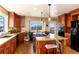 Chef's kitchen with a center island, wooden cabinets, stainless appliances, and mountain views at 5549 Lake Gulch Rd, Castle Rock, CO 80104