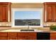 Modern kitchen sink with granite countertops and backsplash, showcasing picturesque outdoor views at 5549 Lake Gulch Rd, Castle Rock, CO 80104