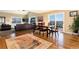 Open-concept living room with a dining area, plush leather seating, and scenic views at 5549 Lake Gulch Rd, Castle Rock, CO 80104