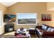 Cozy living room with a mountain view from a large window at 5549 Lake Gulch Rd, Castle Rock, CO 80104