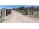 Gated driveway and landscaped entrance to the property with mature trees at 5549 Lake Gulch Rd, Castle Rock, CO 80104