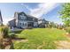 A large, beautifully landscaped backyard with grass, a patio, and an outdoor kitchen area at 3256 Offbeaten Pl, Castle Rock, CO 80108