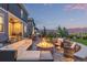 Beautiful backyard featuring a stone fire pit, comfortable seating, and manicured landscaping at 3256 Offbeaten Pl, Castle Rock, CO 80108