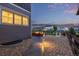 A beautiful landscaped backyard with a stone path that leads to an outdoor fire pit area with comfortable seating at 3256 Offbeaten Pl, Castle Rock, CO 80108