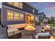 Outdoor patio with a built in fire pit, comfortable seating, and space for entertaining at 3256 Offbeaten Pl, Castle Rock, CO 80108
