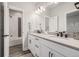 Well-lit bathroom featuring dual sinks, modern fixtures, and a shower-over-tub for a luxurious experience at 3256 Offbeaten Pl, Castle Rock, CO 80108