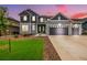Charming two-story home featuring a three-car garage and a well-manicured front yard with lush green grass at 3256 Offbeaten Pl, Castle Rock, CO 80108