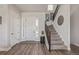 Inviting foyer with a staircase, stylish decor, and wood flooring, creating a warm entrance at 3256 Offbeaten Pl, Castle Rock, CO 80108