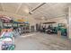 Spacious two car garage with a golf cart, storage shelves, and lots of open parking space at 3256 Offbeaten Pl, Castle Rock, CO 80108