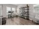 Stylized home office space with hard surface floors, large bookshelf, a modern desk, and comfortable seating at 3256 Offbeaten Pl, Castle Rock, CO 80108