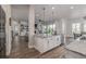 Open kitchen island overlooking living room and eating nook with white cabinets at 3256 Offbeaten Pl, Castle Rock, CO 80108