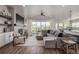 Bright and airy living room with a fireplace, large sectional sofa, and sliding doors to the backyard at 3256 Offbeaten Pl, Castle Rock, CO 80108