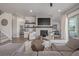 Bright, open living room with fireplace, floating shelves, and comfortable seating area at 3256 Offbeaten Pl, Castle Rock, CO 80108