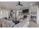 Spacious living room featuring a fireplace, comfortable seating, and seamless flow to the foyer and staircase at 3256 Offbeaten Pl, Castle Rock, CO 80108
