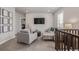 Upstairs living room with cozy gray sofa and chair, TV, and modern decor, ideal for relaxation at 3256 Offbeaten Pl, Castle Rock, CO 80108