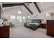 Inviting main bedroom with high ceilings, wood beams, and large windows offering serene views at 3256 Offbeaten Pl, Castle Rock, CO 80108