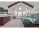 Tranquil main bedroom featuring high ceilings, wood beams, and a large dresser for ample storage at 3256 Offbeaten Pl, Castle Rock, CO 80108