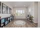 Spacious playroom with abundant natural light, hardwood floors, custom storage, and fun area rug at 3256 Offbeaten Pl, Castle Rock, CO 80108