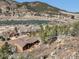 Aerial view of a house near a lake and mountains at 113 Oakdale Dr, Palmer Lake, CO 80133