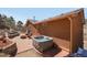 Backyard patio featuring a hot tub, a seating area with a fire pit, and outdoor decor at 113 Oakdale Dr, Palmer Lake, CO 80133