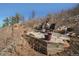 Cozy backyard patio with comfortable seating and scenic natural surroundings, perfect for outdoor enjoyment at 113 Oakdale Dr, Palmer Lake, CO 80133