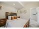 Cozy bedroom featuring a plush bed, dark wood accents, and decorative world map wall art at 113 Oakdale Dr, Palmer Lake, CO 80133