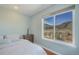 Well-lit bedroom with an oversized window with mountain views at 113 Oakdale Dr, Palmer Lake, CO 80133