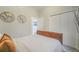 Bright bedroom featuring neutral decor, a plush bed, and decorative world map wall art at 113 Oakdale Dr, Palmer Lake, CO 80133