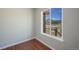 Bedroom with a window showcasing mountain views and hardwood floors at 113 Oakdale Dr, Palmer Lake, CO 80133