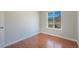 Bedroom with a window showcasing mountain views and hardwood floors at 113 Oakdale Dr, Palmer Lake, CO 80133