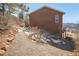 Side exterior of home with stone landscaping and walk way leading up to the house at 113 Oakdale Dr, Palmer Lake, CO 80133