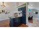 Eat-in kitchen with granite counters and island, adjacent to living room with fireplace at 113 Oakdale Dr, Palmer Lake, CO 80133