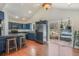Well-lit kitchen features blue cabinets, stainless steel appliances, wood flooring, and sliding doors to the outside at 113 Oakdale Dr, Palmer Lake, CO 80133