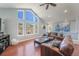 Bright living room featuring vaulted ceiling, large windows with scenic views, and comfortable seating at 113 Oakdale Dr, Palmer Lake, CO 80133