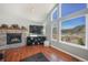 Cozy living room featuring a fireplace and large windows with stunning mountain views at 113 Oakdale Dr, Palmer Lake, CO 80133