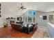 Beautiful living room with a stone fireplace, hardwood floors, vaulted ceiling, and scenic mountain views at 113 Oakdale Dr, Palmer Lake, CO 80133